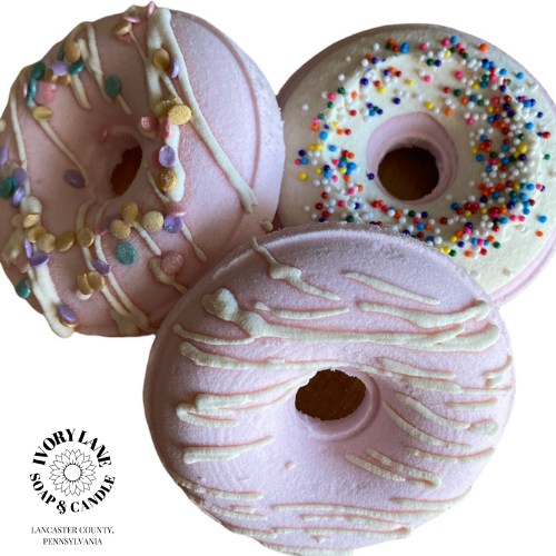 pink donut bath bombs white background
