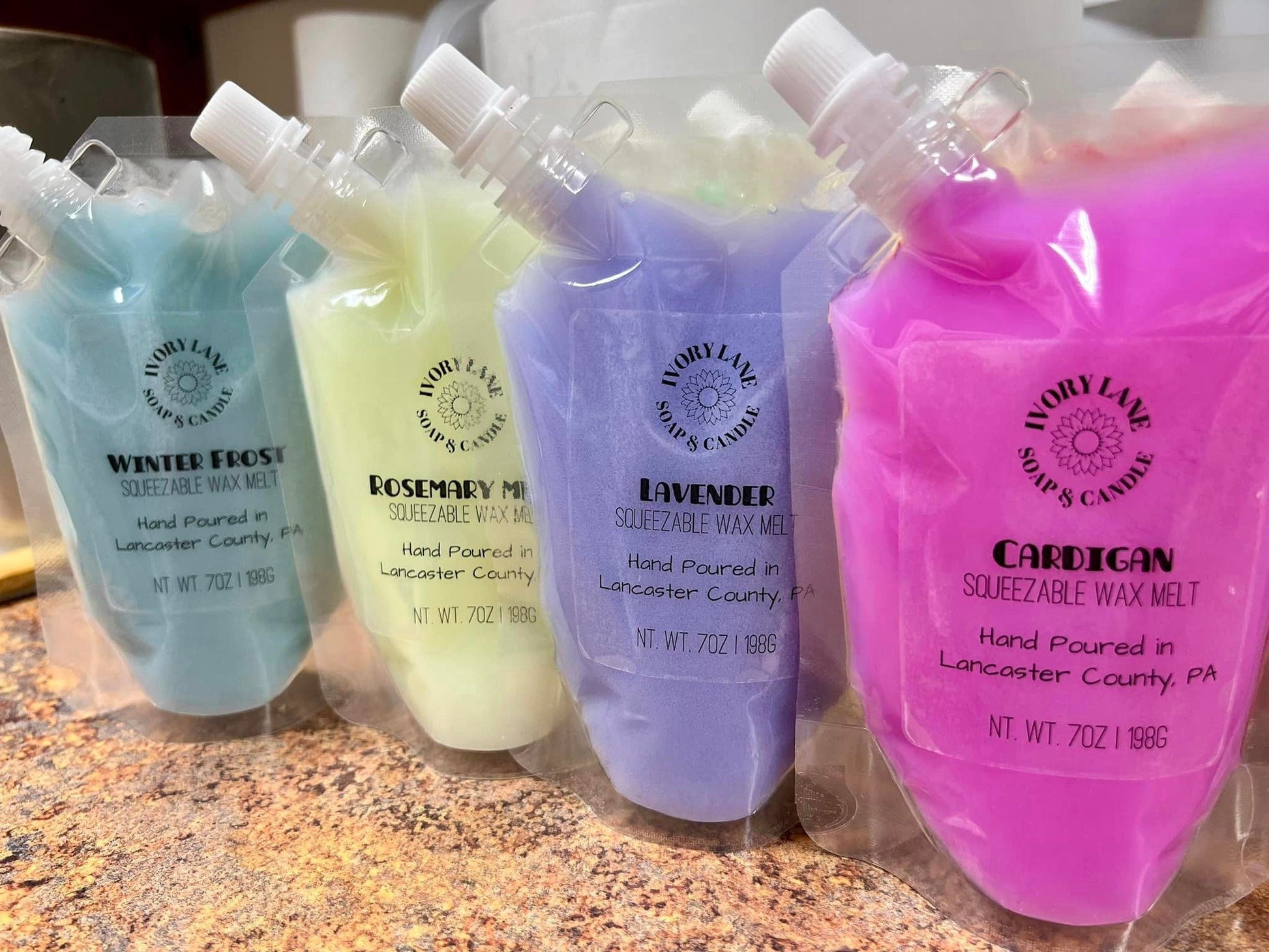 Blue yellow purple and pink wax melts on counter